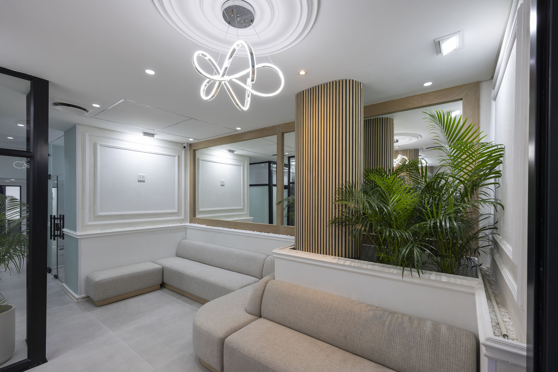The Doctor Care waiting lounge with sofas and palms